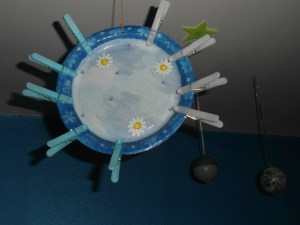 A paper plate sun with peg rays to attach every morning