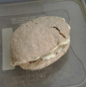 A single, solitary strawberry macaron left