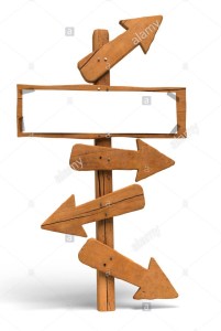 may-arrows-on-a-wooden-post-and-a-white-sign-for-writing-a-message-D6WY0K